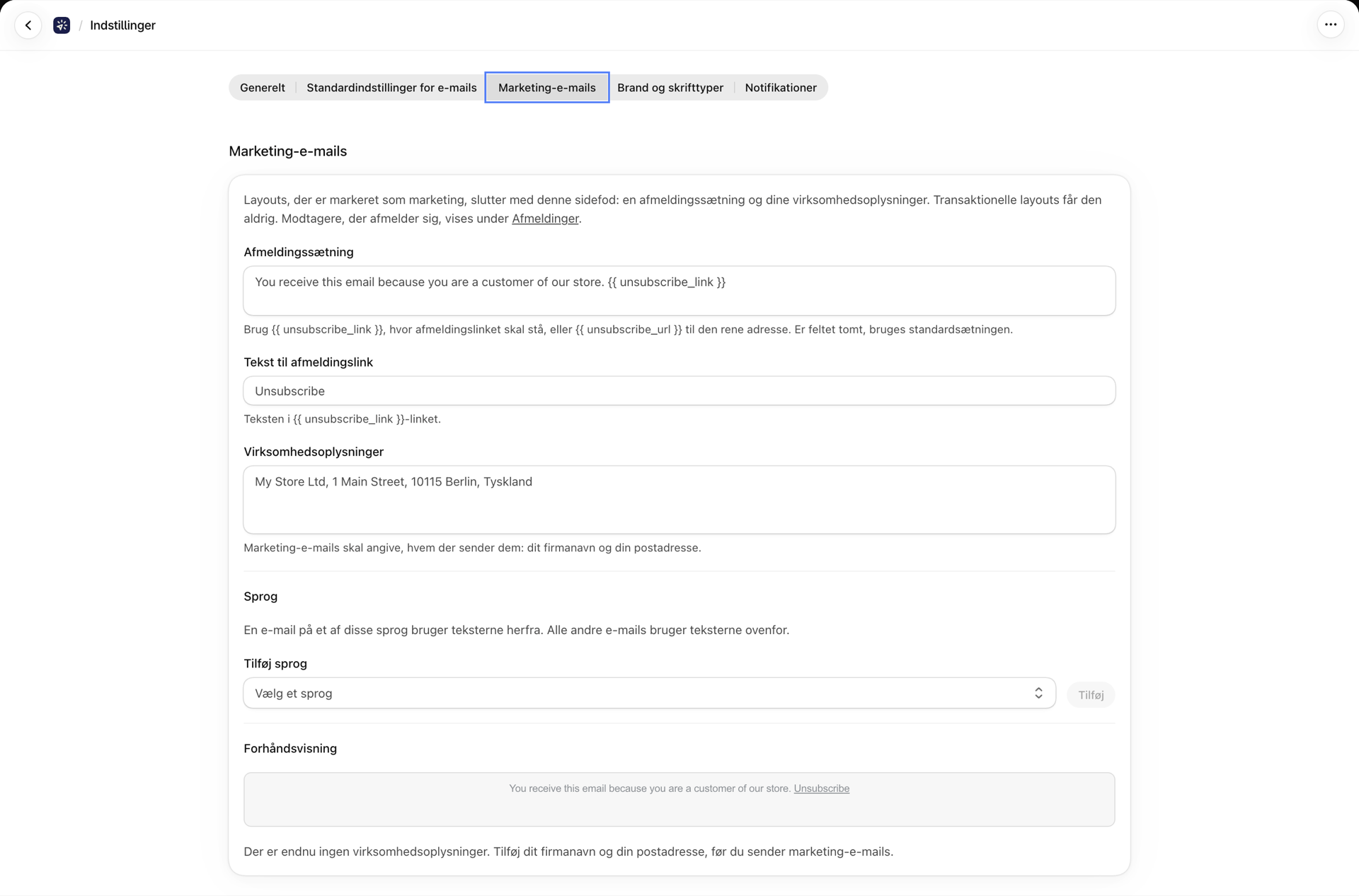 Fanen »Marketing-e-mails« under »Indstillinger« med afmeldingssætningen, linkteksten, oplysningerne om virksomheden og et afsnit om sprog